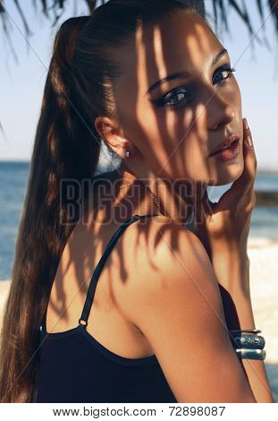 Portrait Of Pretty Young Woman With Long Hair Posing On Beach