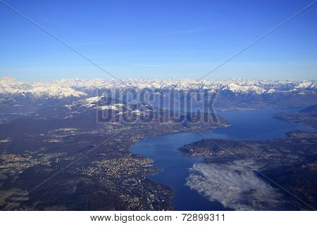 Aerial view of a mountain lake surrounded by settlements