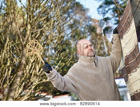 Man And Carpet Beater