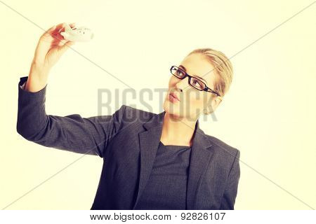 Beautiful businesswoman with plane toy in hand