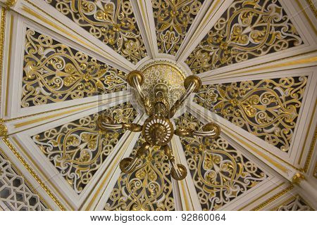 Ceiling And Chandelier Detail In a Gold Room