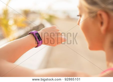 Woman checking fitness and health tracking wearable device