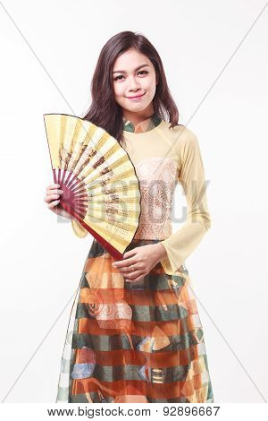 Beautiful Vietnamese Young Woman With Modern Style Ao Dai Holding A Paper Fan On White Background