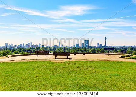 Panoramic view of London cityscape seen from Primrose Hill on a sunny day