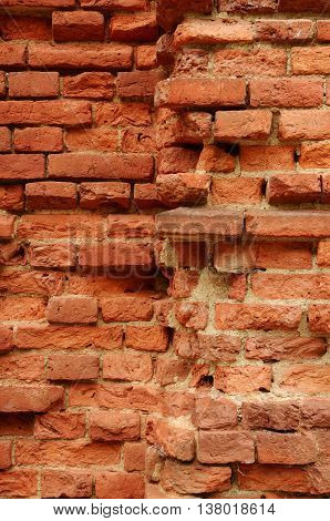 Old brick wall.Walls falling apart and the brick is destroyed by time.