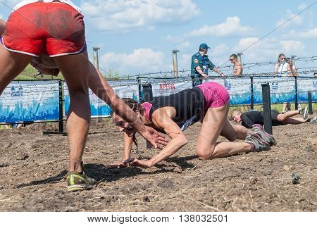 Tyumen, Russia - July 9, 2016: Steel Character extrim race on Voronino Hill. Army Test. People jumping, crawling, passing under a barbed wires or climbing obstacles during extreme obstacle race