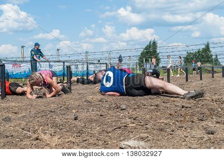 Tyumen, Russia - July 9, 2016: Steel Character extrim race on Voronino Hill. Army Test. People jumping, crawling, passing under a barbed wires or climbing obstacles during extreme obstacle race