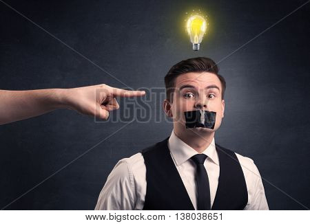 Caucasian hand pointing at businessman with a lightbulb above his head