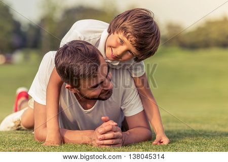 Dad And Son Resting Outdoors