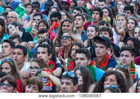PORTO, PORTUGAL - JUL 10, 2016: Portuguese fans during video translation of the football match Portugal - France final of the European championship 2016, in Liberdade Square at city center of Porto. 