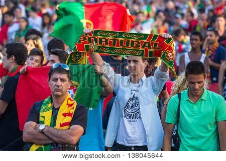 PORTO, PORTUGAL - JUL 10, 2016: Portuguese fans during video translation of the football match Portugal - France final of the European championship 2016, in Liberdade Square at city center of Porto. 