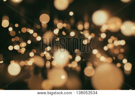 glittering shine bulbs lights background:blur of Christmas wallpaper decorations concept.holiday festival backdrop:sparkle circle lit celebrations display.