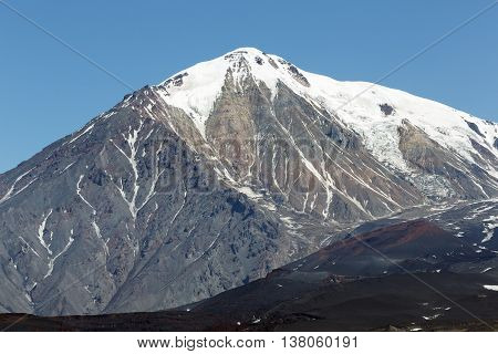Beautiful volcanic landscape of Kamchatka: summer view of cone of Ostry Tolbachik Volcano in a cloudless clear weather. Eurasia Russia Far East Kamchatka Peninsula Klyuchevskaya Group of Volcanoes.