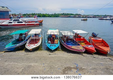 Labuan,Malaysia-July 11,2016:Labuan water taxi waiting for customer in the jetty at Labuan island on 11th July 2016.This is main transport to water village Patau Patau & Muslim Labuan Pearl of Borneo