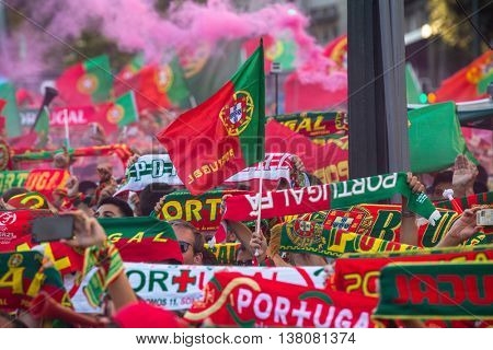 PORTO, PORTUGAL - JUL 10, 2016: Portuguese fans during translation of the football match Portugal - France final of the European championship 2016, in Liberdade Square at city center of Porto. 
