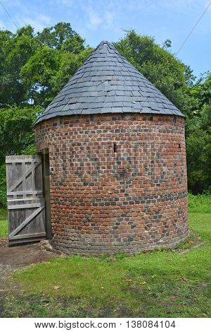 CHARLESTON SOUTH CAROLINA JUNE 28 2016: Smoke houses of Slave cabins in Boone Hall Plantation in Mount Pleasant, the slave houses are insightful, and the Gullah Culture explanation is informative