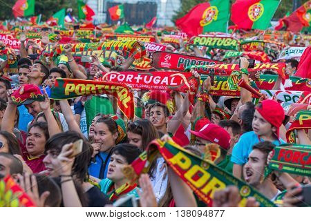 PORTO, PORTUGAL - JUL 10, 2016: Portuguese fans during translation of the football match Portugal - France final of the European championship 2016, in Liberdade Square at city center of Porto. 