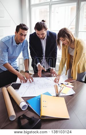 Archtects looking at construction plan in the office
