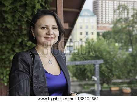 Portrait of a mature businesswoman in a blue evening dress. 