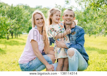 Portrait of young happy family at outdoos