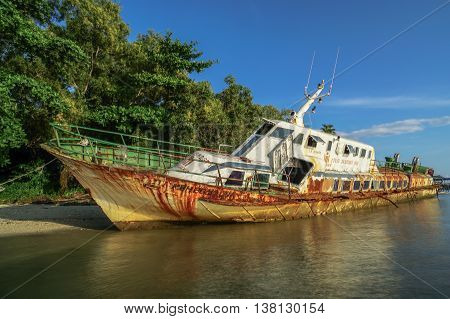 Labuan,Malaysia-July 12,2016: Abandoned broken ferry ship wreck known as Duta Muhibbah Dua beached on sea shore at Labuan island,Malaysia on 12th July 2016.