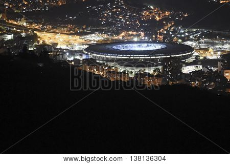 View of the Maracana stadium at night and the city around all lit