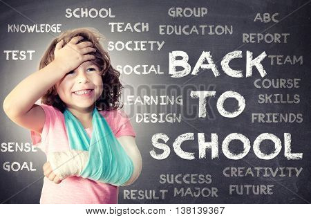Child with broken hand holding for her headback to school concept