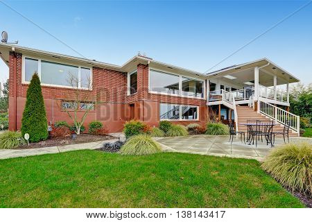 Red Brick House With Tile Roof. Back Yard