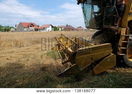 TRNOVEC, CROATIA - JULY 09, 2016: Combine harvester harvest ripe wheat on a farm in Trnovec, Croatia on July 09, 2016
