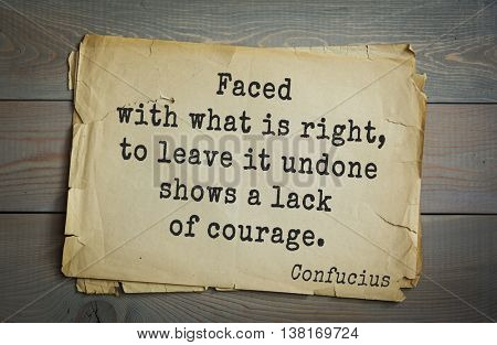 Ancient chinese philosopher Confucius quote on old paper background. Faced with what is right, to leave it undone shows a lack of courage.