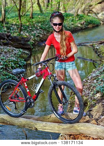 Bikes cycling girl. Girl rides bicycle. Girl cycling fording throught water . Cycling trip is good for health. Cyclist in helmet look at camera.