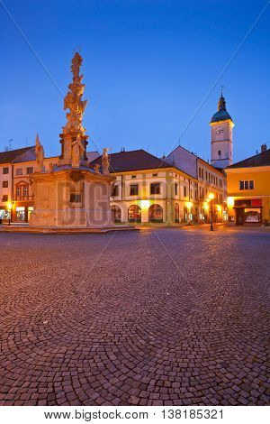 Monument and the town hall tower in a square of the old town of Uherske Hradiste early in the morning.