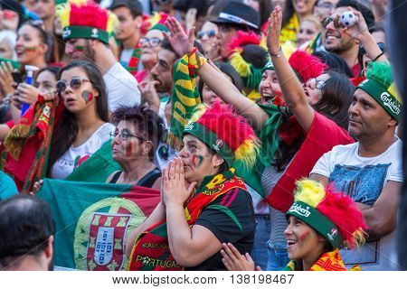 PORTO, PORTUGAL - JUL 10, 2016: Portuguese fans during translation of the football match Portugal - France final of the European championship 2016, in Liberdade Square at city center of Porto. 