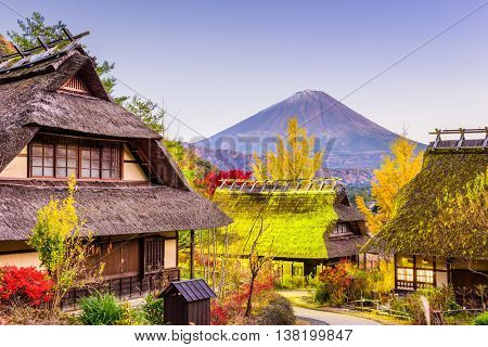 Mt. Fuji, Japan with historic village Iyashi no Sato during an autumn twilight.