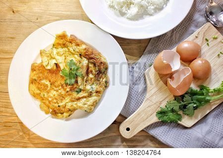 Omelette Thai style and cooking concept on the wooden background