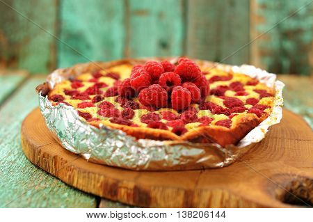 Homemade yummy quark pie with raspberries baked in foil selective focus closeup