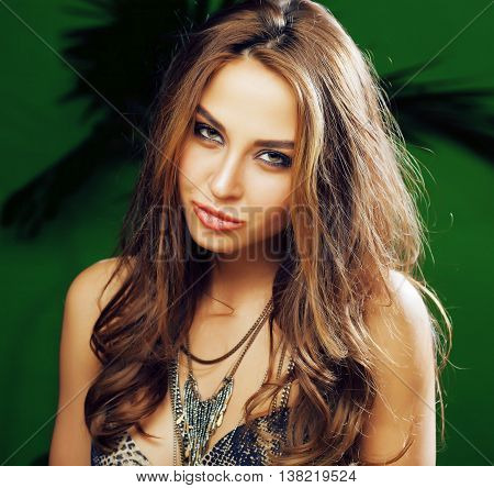 young cute brunette woman on green palm background smiling happy, lifestyle peole concept close up