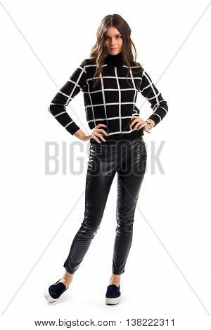 Lady in black checkered sweater. Skinny pants and footwear. Dark autumn outfit. Stylish design of new garment.