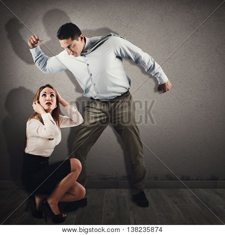 Violent and angry man intimidates a frightened woman