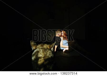 manly husband tenderly embracing his pregnant wife