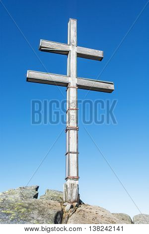 Big cross on the hill Dumbier in Low Tatras mountains. Travelling theme. Beautiful place. Symbolic object. Vertical composition.