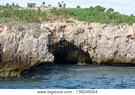 Remote islands in the Indian Ocean waters in Rockingham, Western Australia with green plants and rough limestone caves.