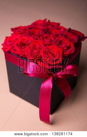Box With Red Roses Over Beige Background
