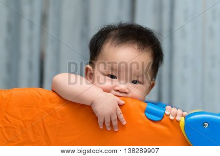 Asian Baby In Playpen