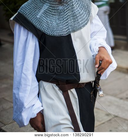 parade with costumes of the Middle Ages. Featured soldier with cooked in metal and armed with sword