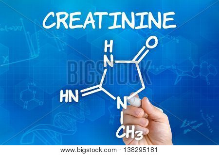 Hand With Pen Drawing The Chemical Formula Of Creatinine
