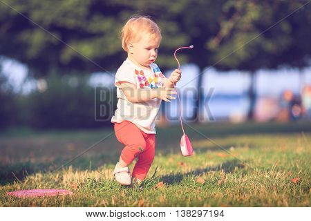 Baby playing on оutdoors. Computer mouse, technologies.