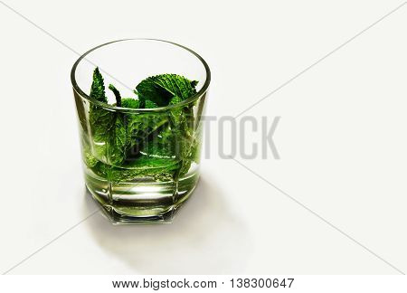 alcoholic cocktail with mint, lemon and gin on a white background