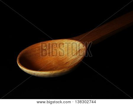 wooden spoon alder on a black background