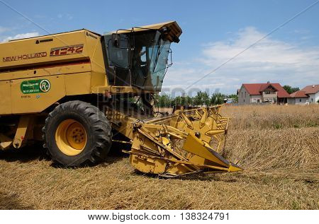 TRNOVEC, CROATIA - JULY 09, 2016: Combine harvester harvest ripe wheat on a farm in Trnovec, Croatia on July 09, 2016